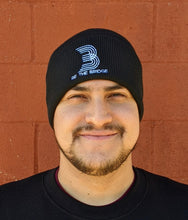 Man wearing black beanie with 'B' and 'Be the Bridge' in white lettering.