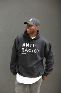 Man wearing black hoodie with 'Anti-Racist' in white lettering.