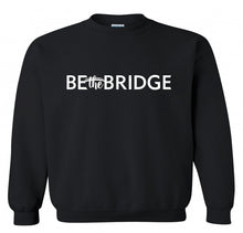 Black sweatshirt with 'Be the Bridge' in white lettering.