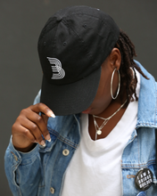 girl wearing black B logo cap